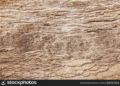 A natural texture background of hundreds of layers of calcium carbonate formed over years from one of the mineral springs at Mammoth Hot Springs in Yellowstone National Park.