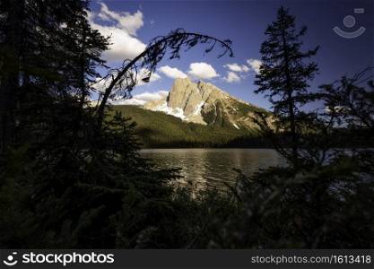 A natural window looking out across Emerald Lake towards Mount Burgess within Yoho National Park in British Columbia.