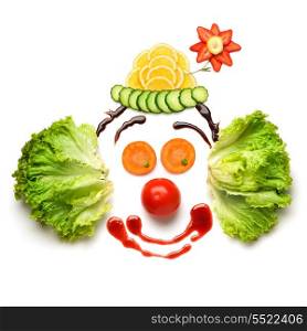 A nice and funny edible clown, made of strawberries, lemons, salad and so on.