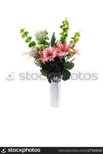 A nice bunch of silk lilies with some green branches in a white vasefor white background.