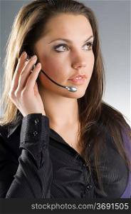 a nice call operator in dark skirt with headphones