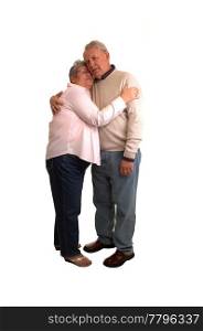 A nice couple of seniors standing in the studio and hugging each other,for white background.