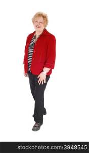 A nice senior woman in her seventy&rsquo;s standing in a red jacket, with blondhair isolated for white background.