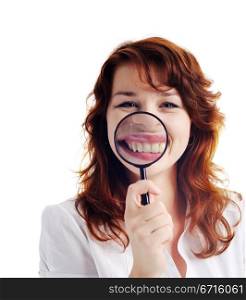 A nice woman with magnifying glass showing her teeth