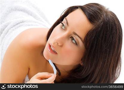 a nice young woman with black hair laying down on the white floor and showing her shoulder