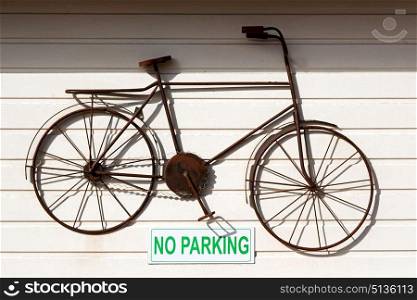 a no parkin signal in the garage door and antique bicycle hanging