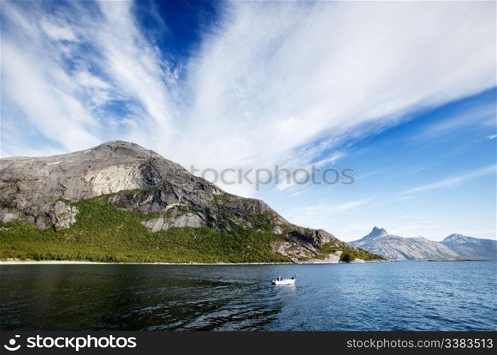 A Norwegian fjord with a small white boat