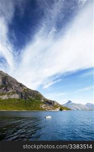 A Norwegian fjord with a small white boat