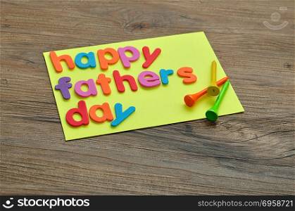 A note with the word happy fathers day and golf tees
