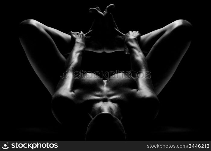 A nude sexy lady in a juicy pose holding feet together.