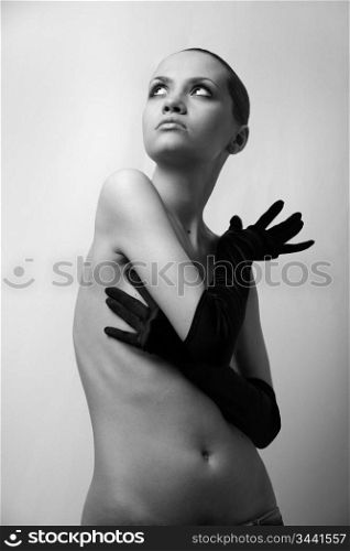 A nudel elegant girl with the gloves. Studio fashion photo.