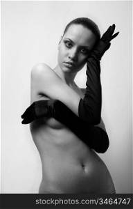 A nudel elegant girl with the gloves. Studio fashion photo.