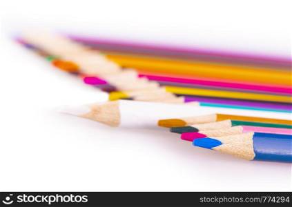 A number of colored pencils on a white background
