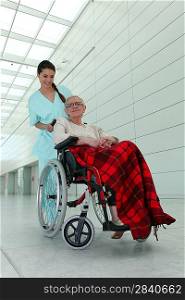 a nurse and an old lady in wheelchair