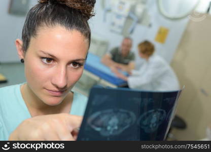 a nurse checking a xray