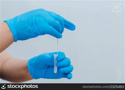 A nurse is using a cotton swab dipped in an antigen (ATK) test kit as a test kit for COVID-19.