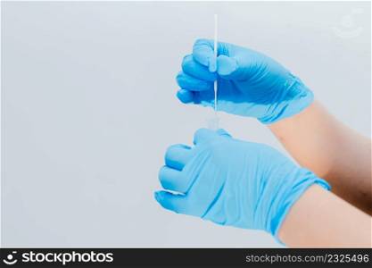 A nurse is using a cotton swab dipped in an antigen (ATK) test kit as a test kit for COVID-19.