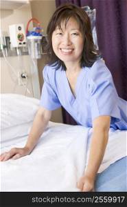 A Nurse Making A Bed In A Hospital Ward