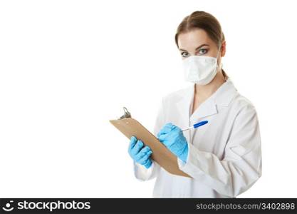 A nurse wearing a mask to keep her safe from possible infection, and holding a clipboard and pen to gather patient information.
