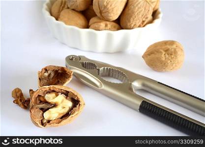A nutcracker and walnuts in a bowl