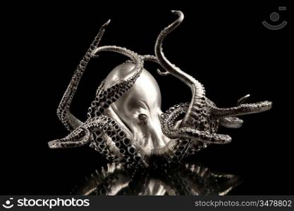 A octopus made of silver, isolated on black background.