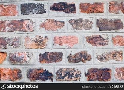 a old and aged brickwall which consists of many different colors
