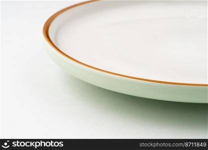 A one ceramic green plate isolated on white background. One ceramic green plate isolated on white background