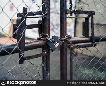 A padlock on a rusty old gate