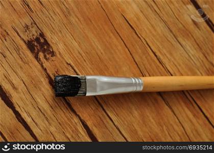 A paint brush with black paint