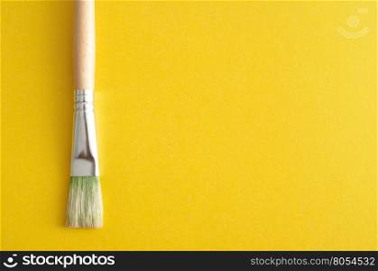 A paintbrush isolated on a yellow background