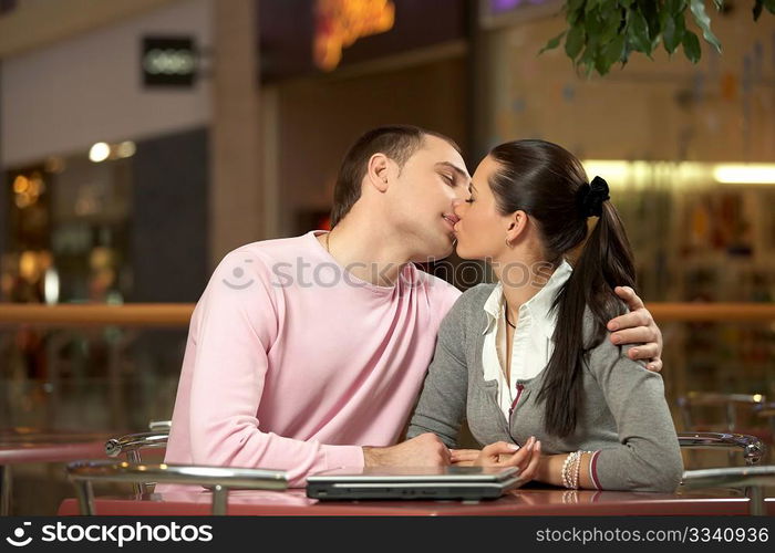 A pair is kissed after a dinner-wagon in a cafe