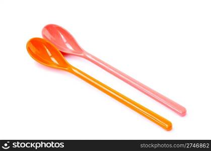 A pair of colorful plastic spoons on a white background