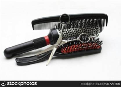 A pair of hairdressers scissors, a comb and brushes, the basic equipment for any hairdresser