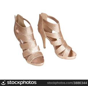 A pair of modern high cold colour high heels isolated for white&#xA;background.&#xA;