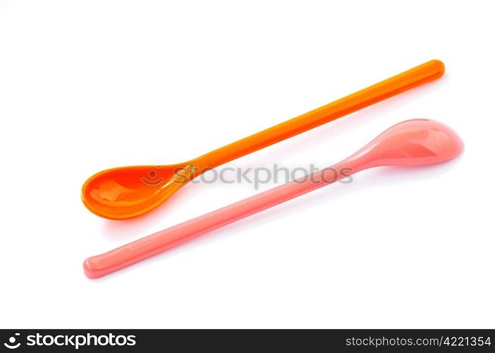 A pair of plastic spoons on a white background