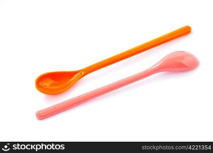 A pair of plastic spoons on a white background