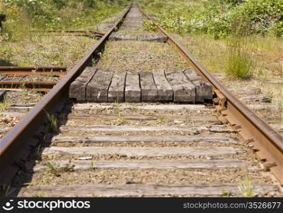 A pair of railroad tracks stretching off in a dtraight line o infinity. This kind of image is symbolic to many linked activities in business duch as receding goals, etc.