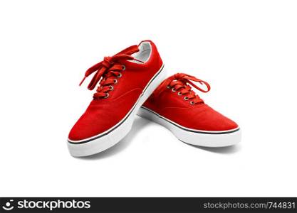 A pair of Red canvas shoes isolated on white background with clipping path. A pair of green canvas shoes isolated on white