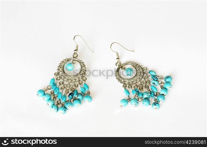 A pair of Tibetan style earrings on a white background