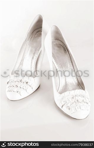 a pair of white shoes on a white background. close-up