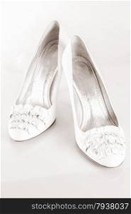 a pair of white shoes on a white background. close-up