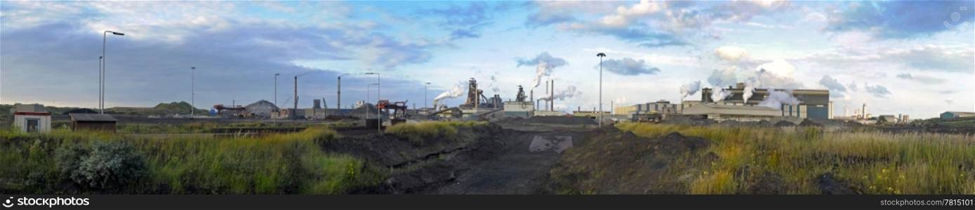 A panorama of a steel plant, with from left to right, the process flow from iron ore and coal, via the blast furnace process to the oxygen steel plant