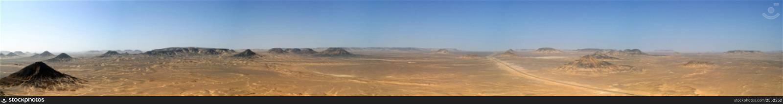 A panoramic stock photograph of the Black Desert in Egypt.