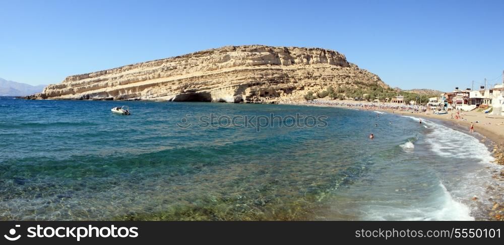 A panoramic view of Matala Bay on Crete, Greece, a famous former Hippie hang-out and popular summer resort.