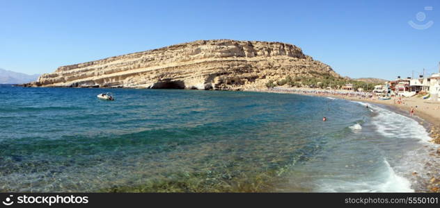 A panoramic view of Matala Bay on Crete, Greece, a famous former Hippie hang-out and popular summer resort.