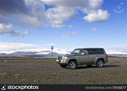 A parking lot in the middle of nowhere, with a view on the Icelandic Tundra and the huge Vatnajokull glacier along the Sprengisandur Highland Route