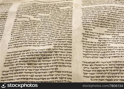 A part of the Hebrew text from a portion of a Torah scroll. This scroll is estimated to be 150 years old and is wrinkled and spotted with age.