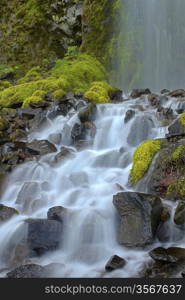 A peaceful waterfall found in the mountains of Oregon.