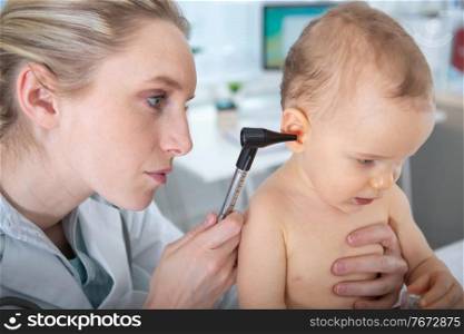 a pediatrician taking babys temperature