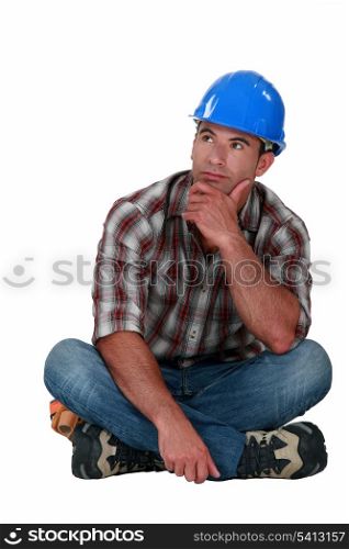 A pensive manual worker.